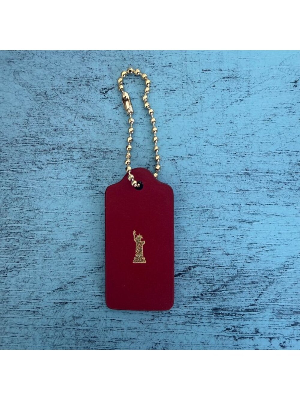 Coach Red Leather Keychain Tag With Gold Chain And Statue Of Liberty Accent